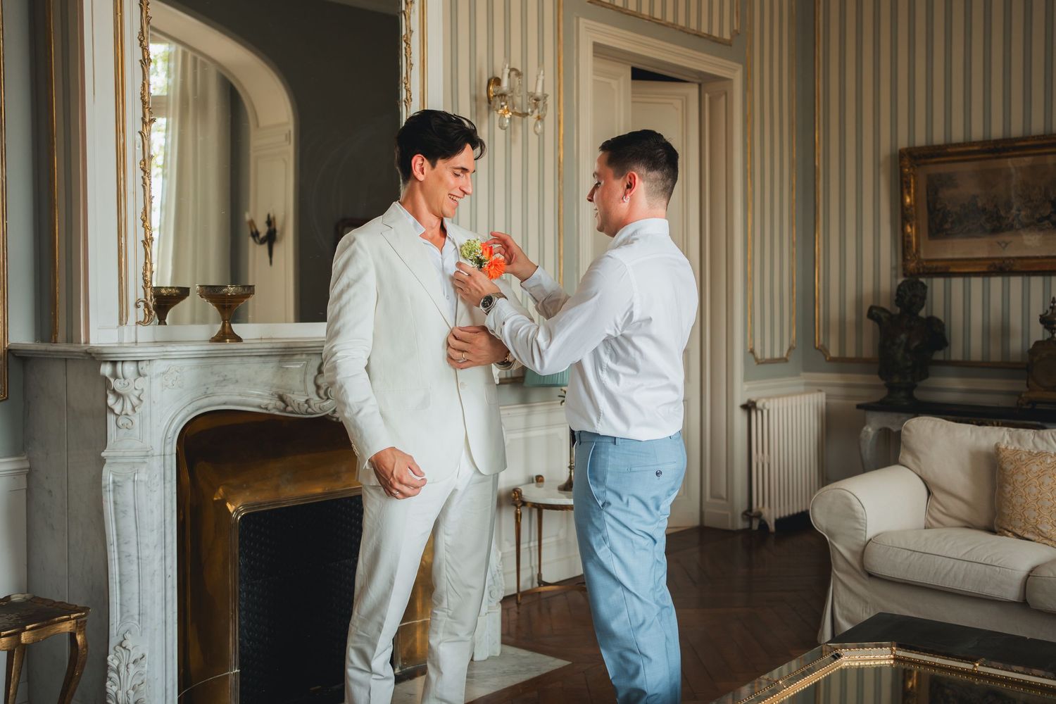 Wedding preparation moments in elegant room with striped wallpaper.