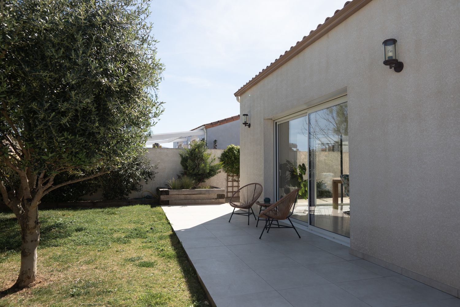 A series of exterior views showing a modern white stucco house with terracotta roof tiles and surrounding landscaping.