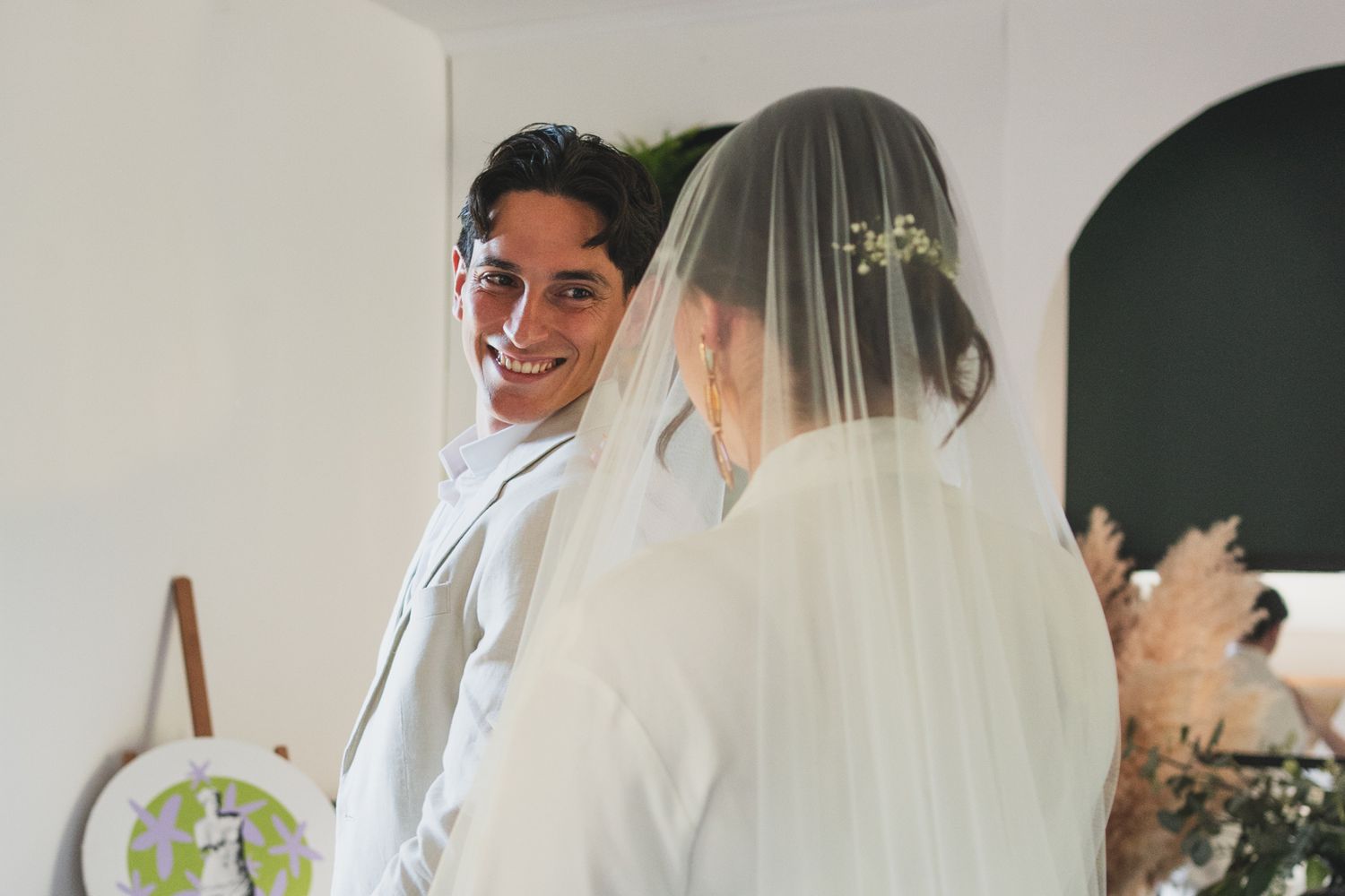 Intimate wedding ceremony moments with white wedding dress and veil details.