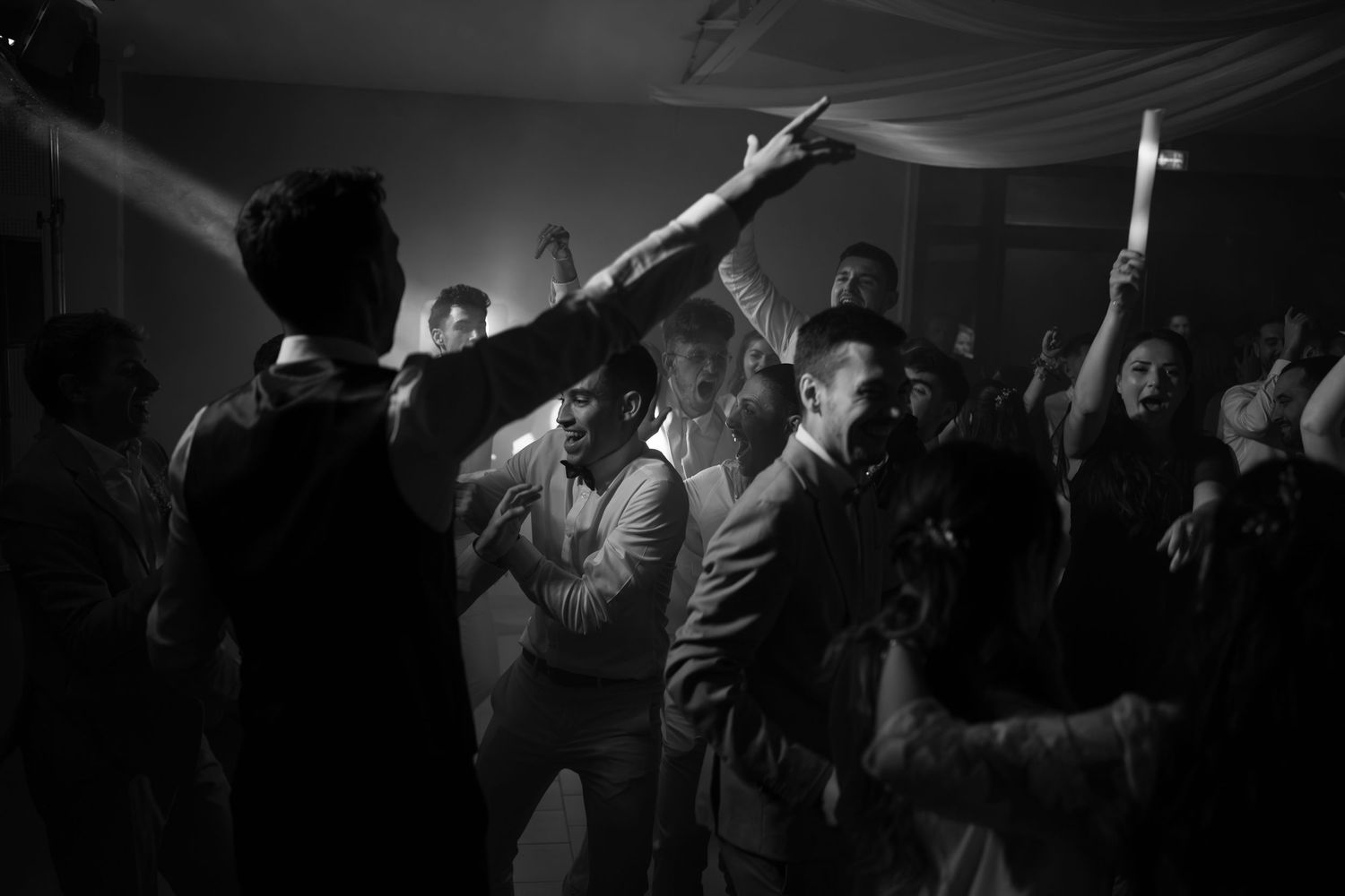 A series of black and white concert photos showing silhouettes of performers on stage with dramatic lighting effects.