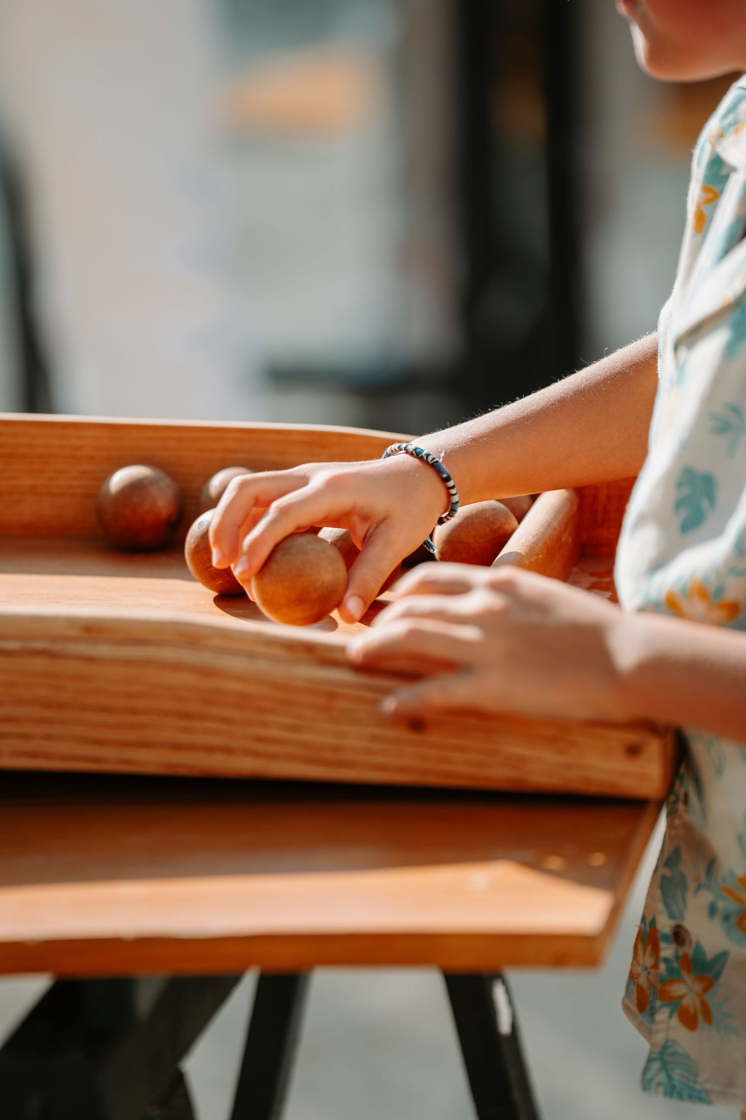 Close-up view of hands working on a wooden surface showing detailed craftsmanship and woodworking skills.