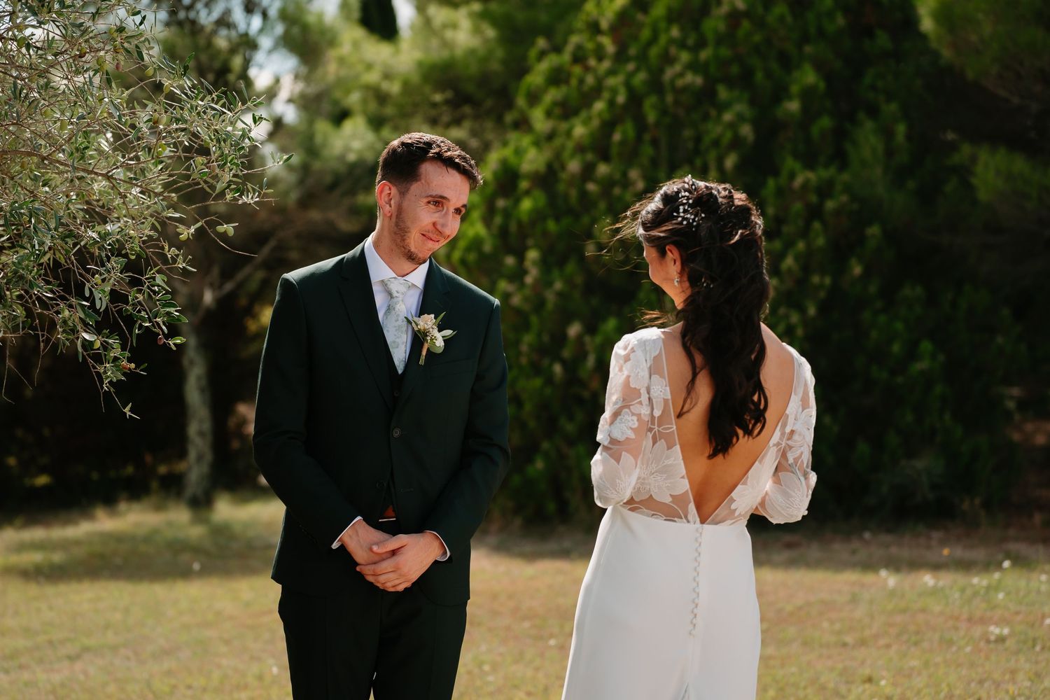 A couple shares a romantic moment in a garden setting during their wedding photoshoot.
