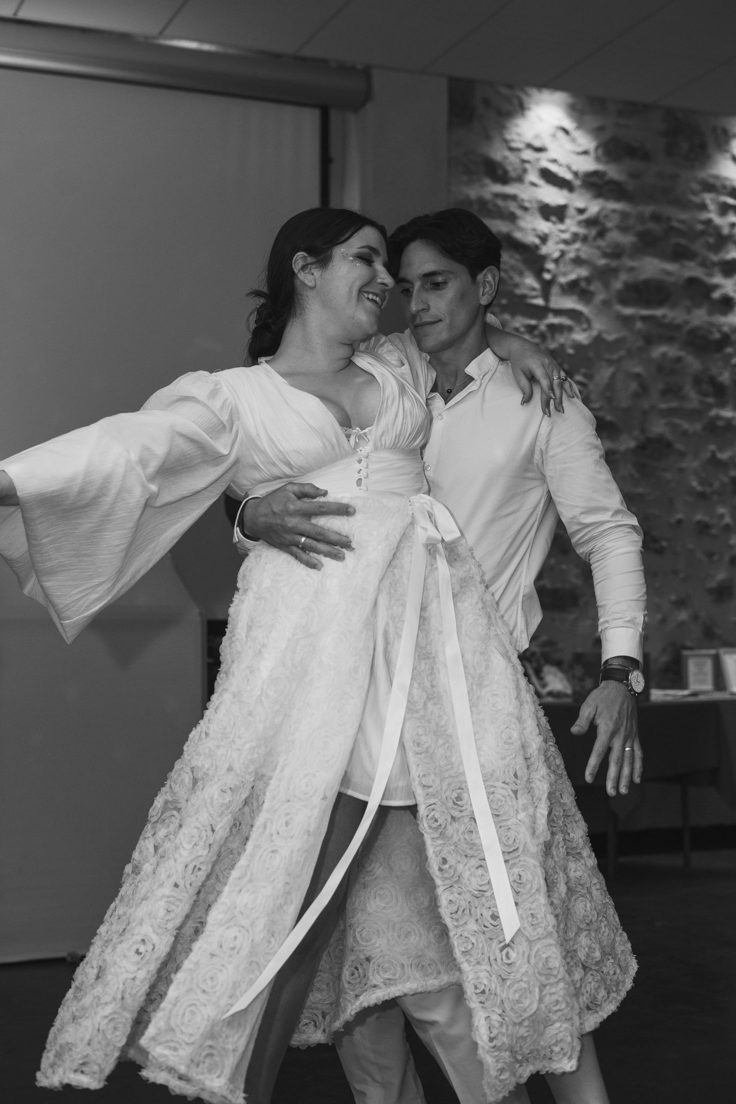 A couple dancing together in white formal attire, captured in a series of romantic dance movements.