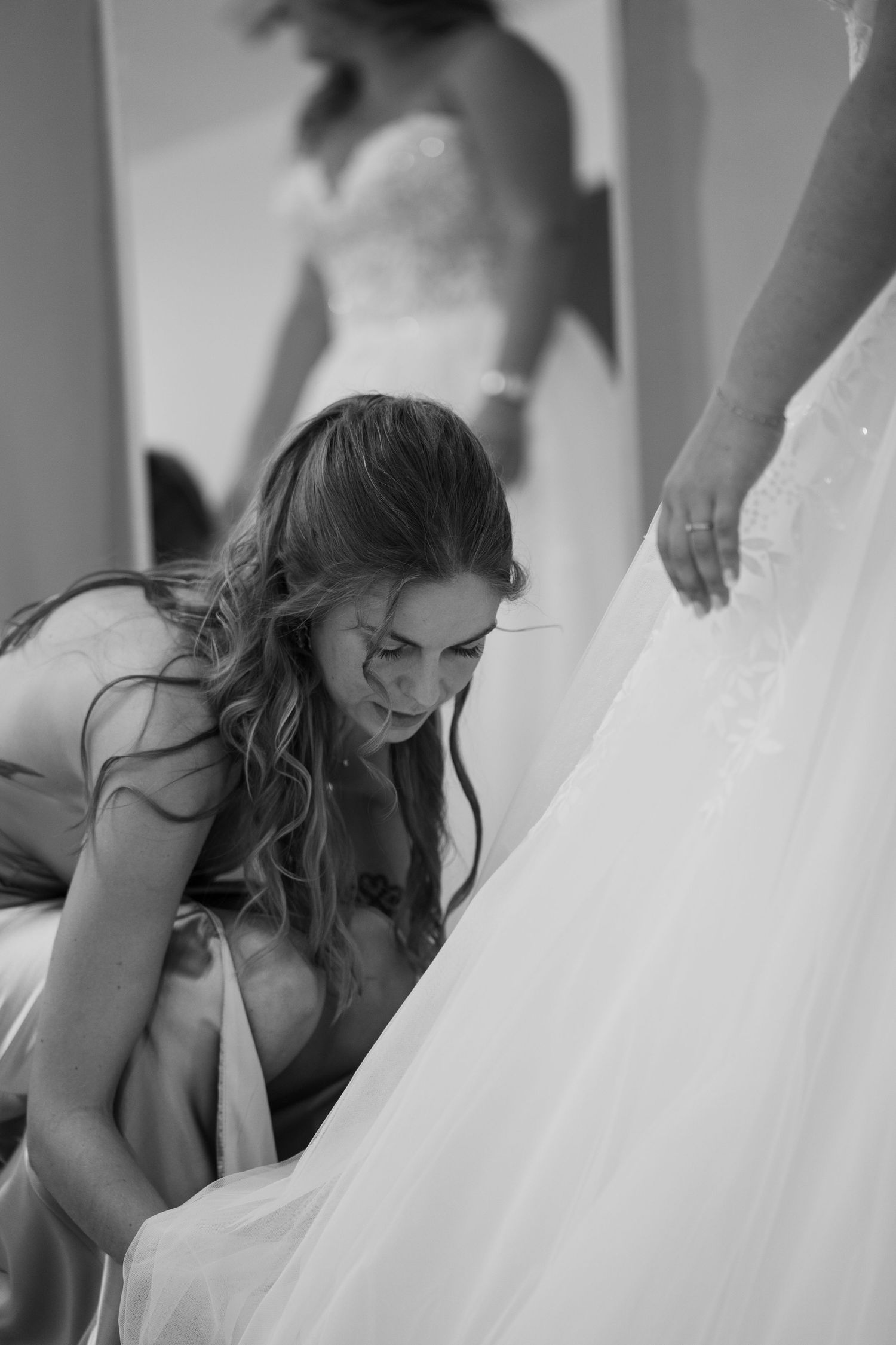 Black and white photos show tender moments between a bride and her loved ones during wedding preparations.