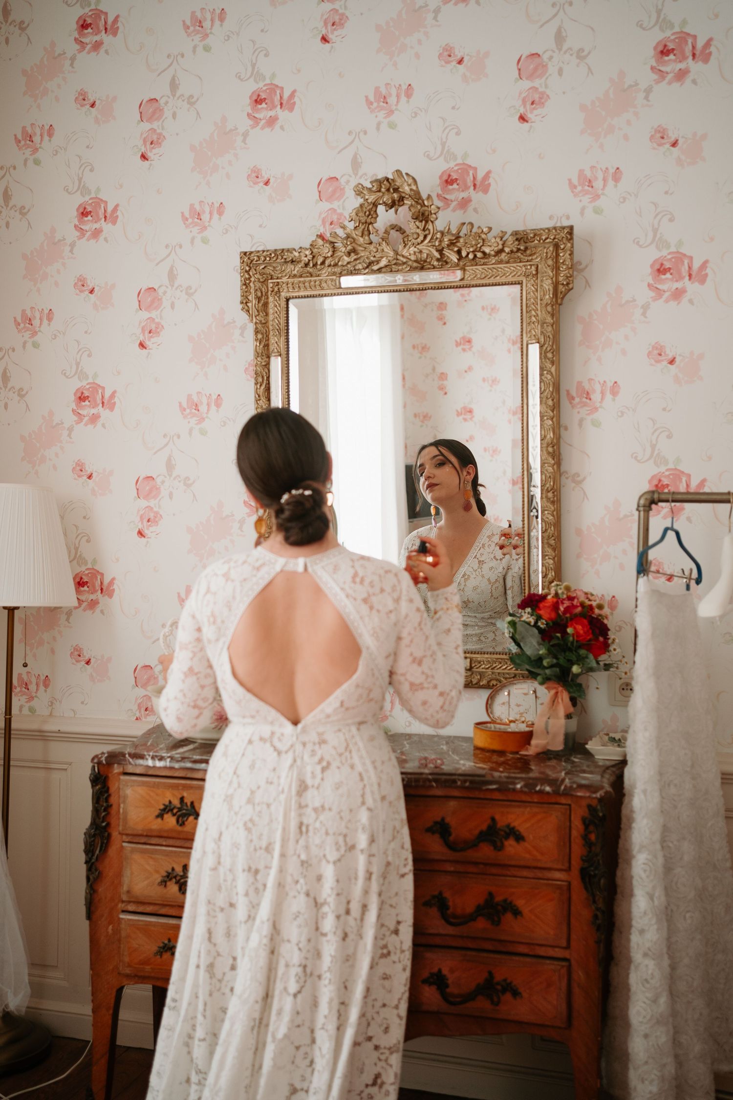 Four sequential photos showing a person in a white lace wedding dress looking at themselves in an ornate gold mirror.