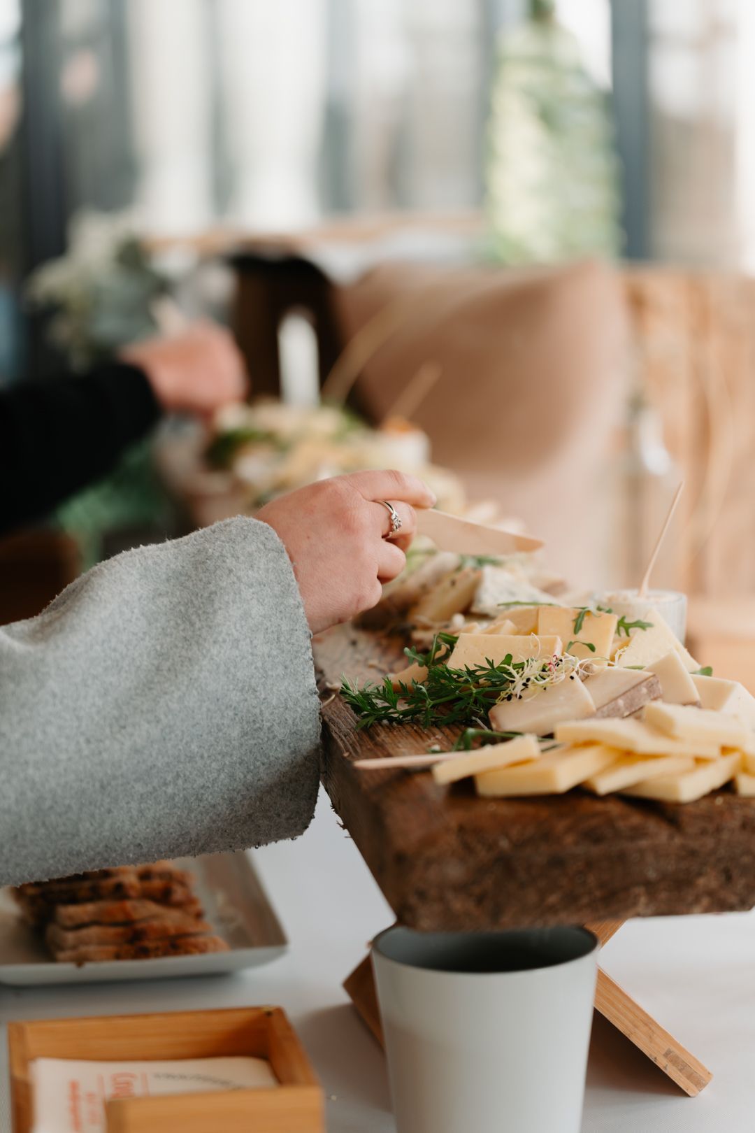 Chef garnishing dishes with fresh herbs and ingredients on white serving plates.