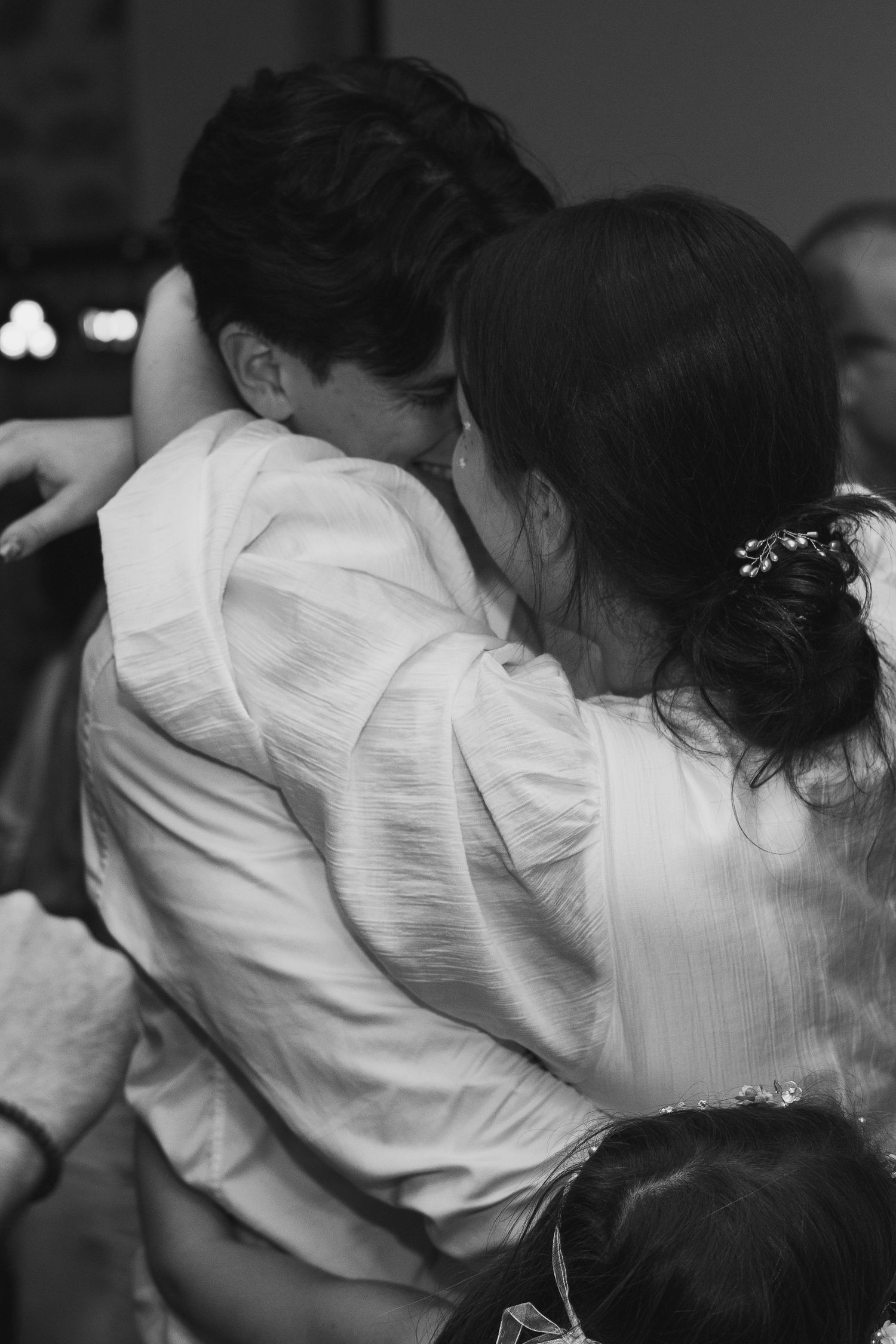 A black and white photo series shows two people embracing in a tender moment.