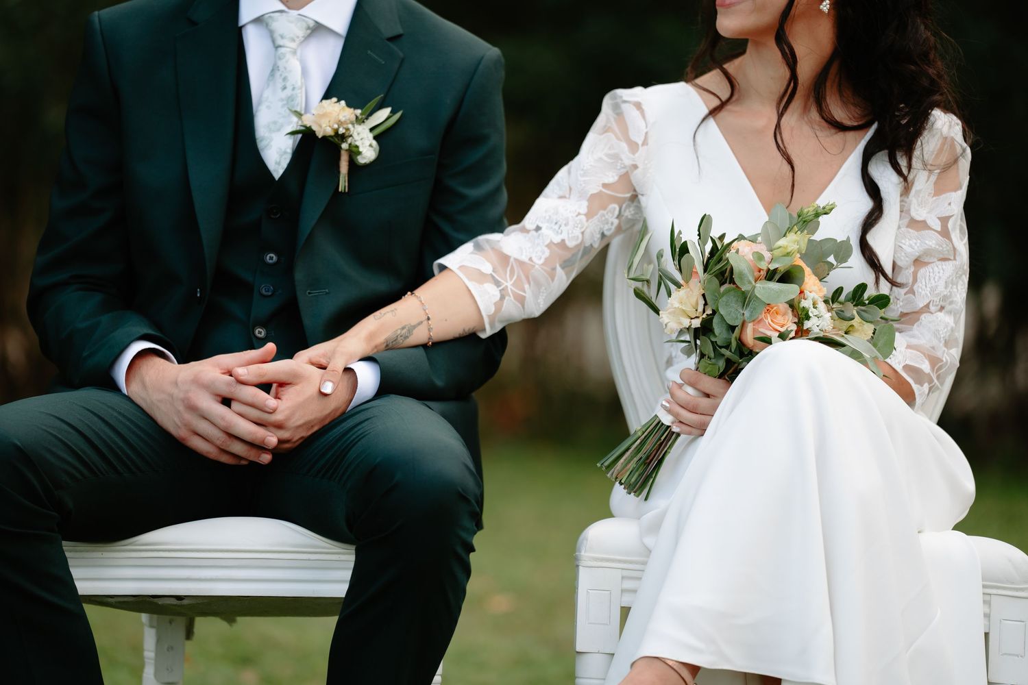 A wedding ceremony moment captured showing signing of documents with elegant white floral arrangements.