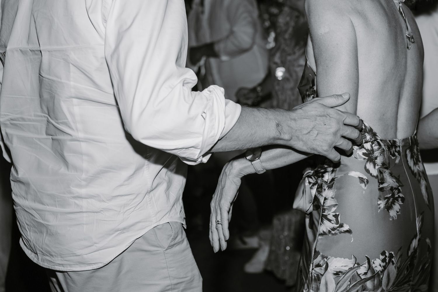Black and white photo shows a crowd of people dancing and socializing at what appears to be a party or celebration.