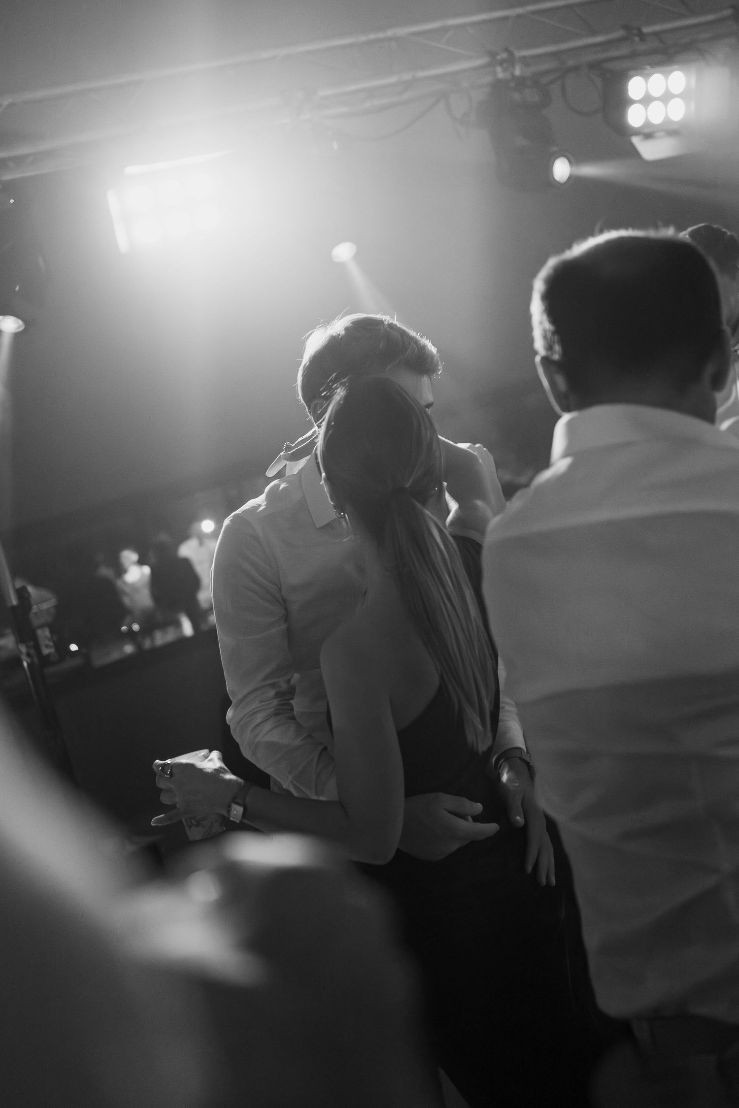 A series of black and white dance floor photos showing couples dancing together in dim lighting.