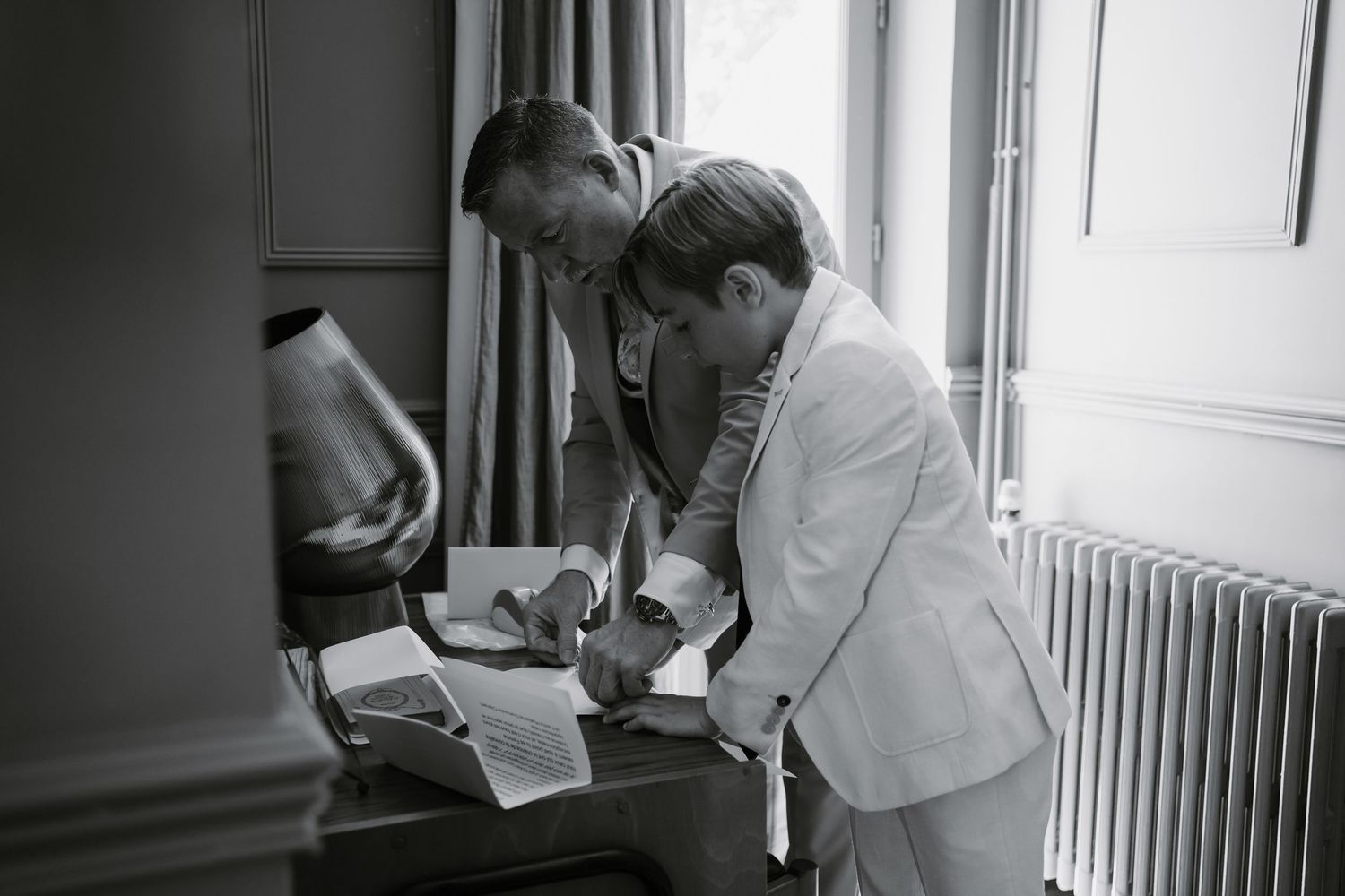 Healthcare professionals in white coats examine medical documents and charts in a clinical setting.