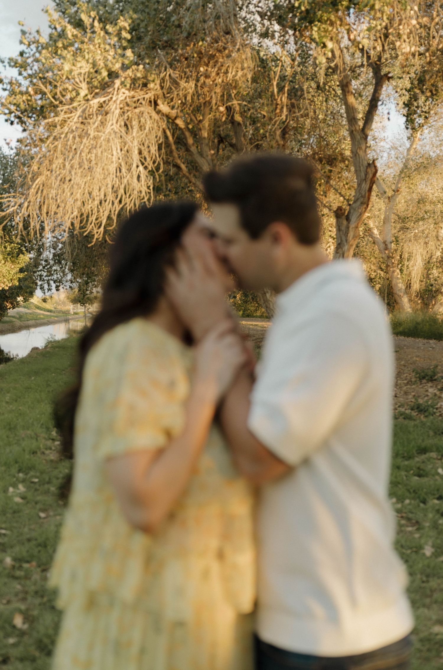 Romantic sunset photoshoot in nature with soft golden lighting.