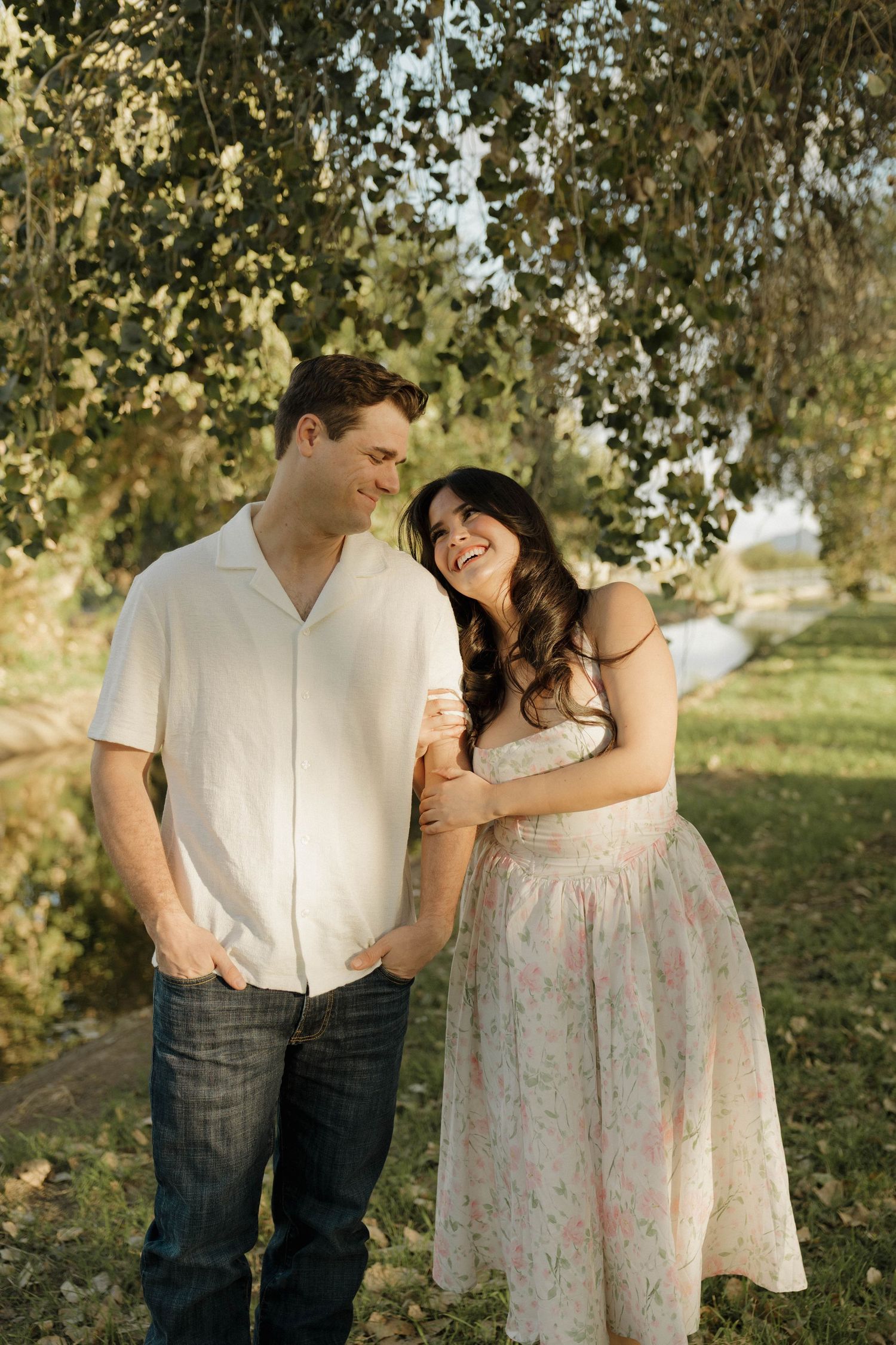 A couple shares tender moments in a series of romantic outdoor photos under sunlit trees.