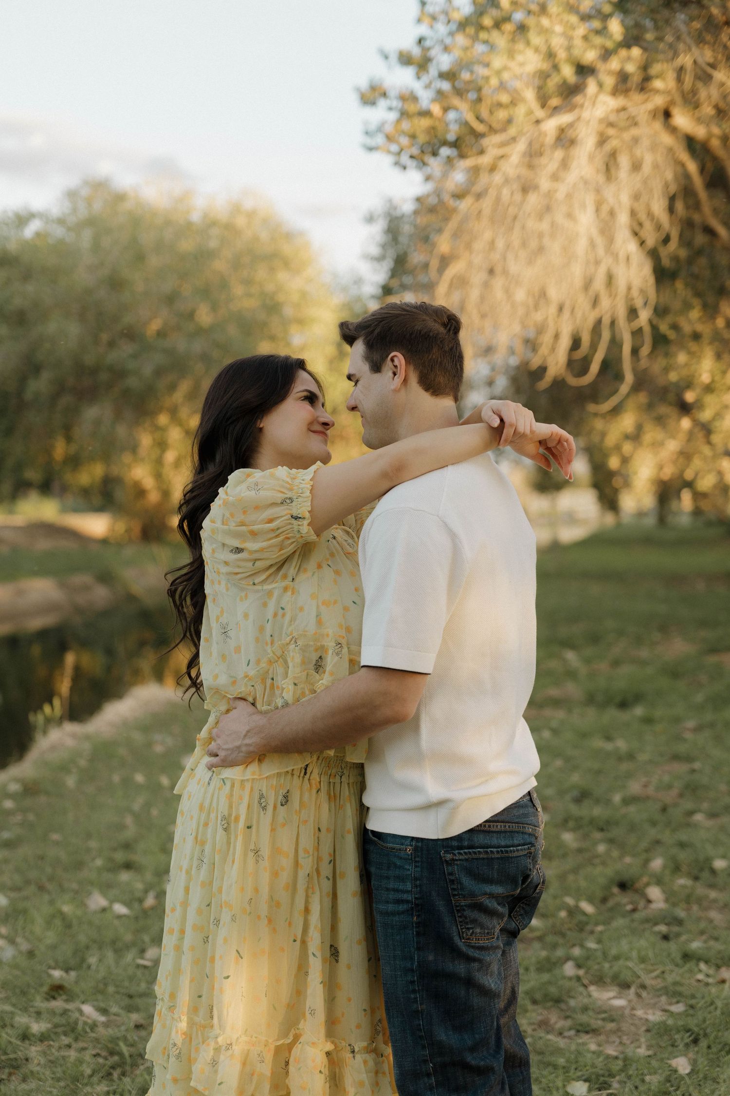 Couple sharing tender moment in autumn park setting.