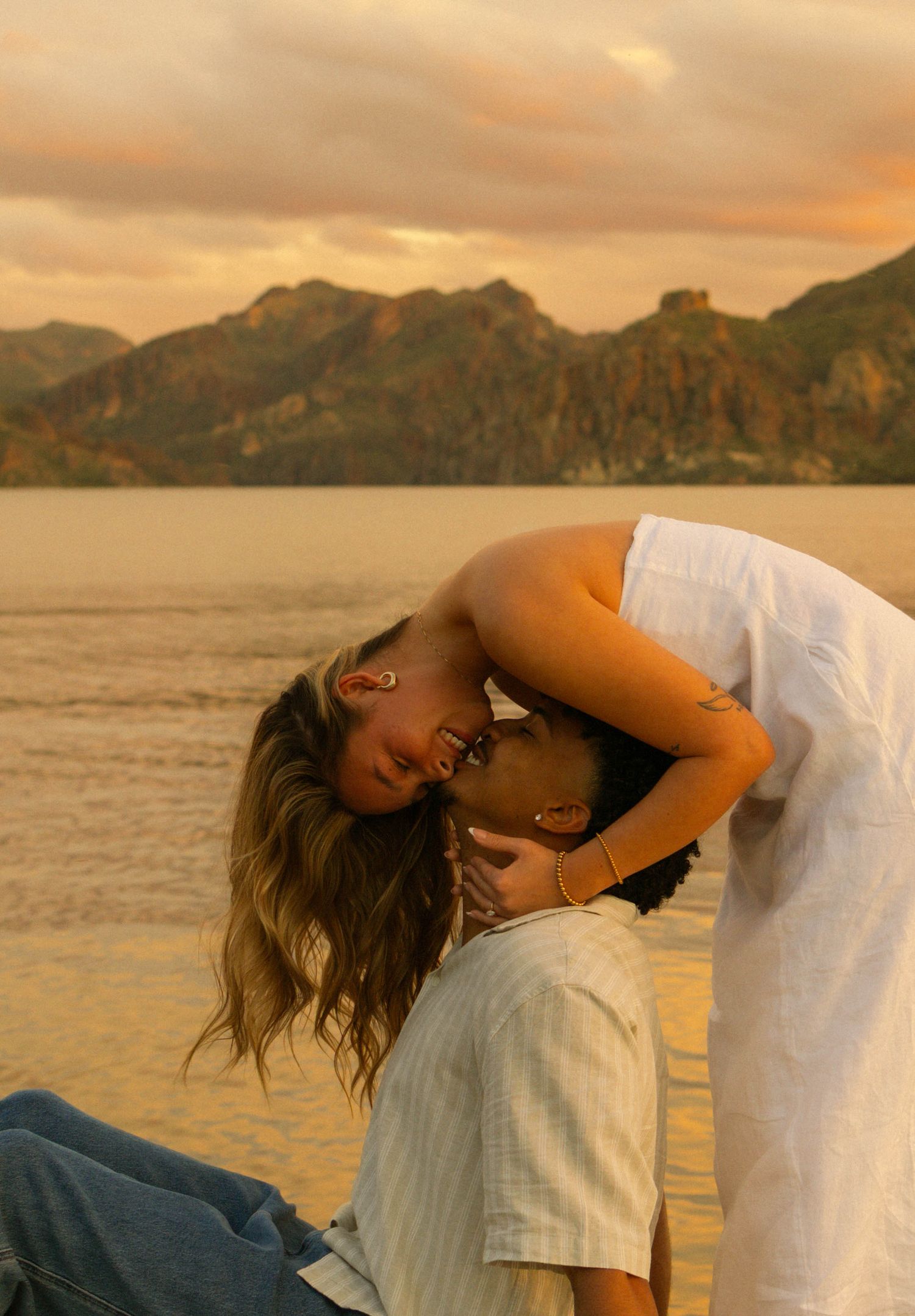 A romantic sequence of intimate moments captured during sunset by the water.