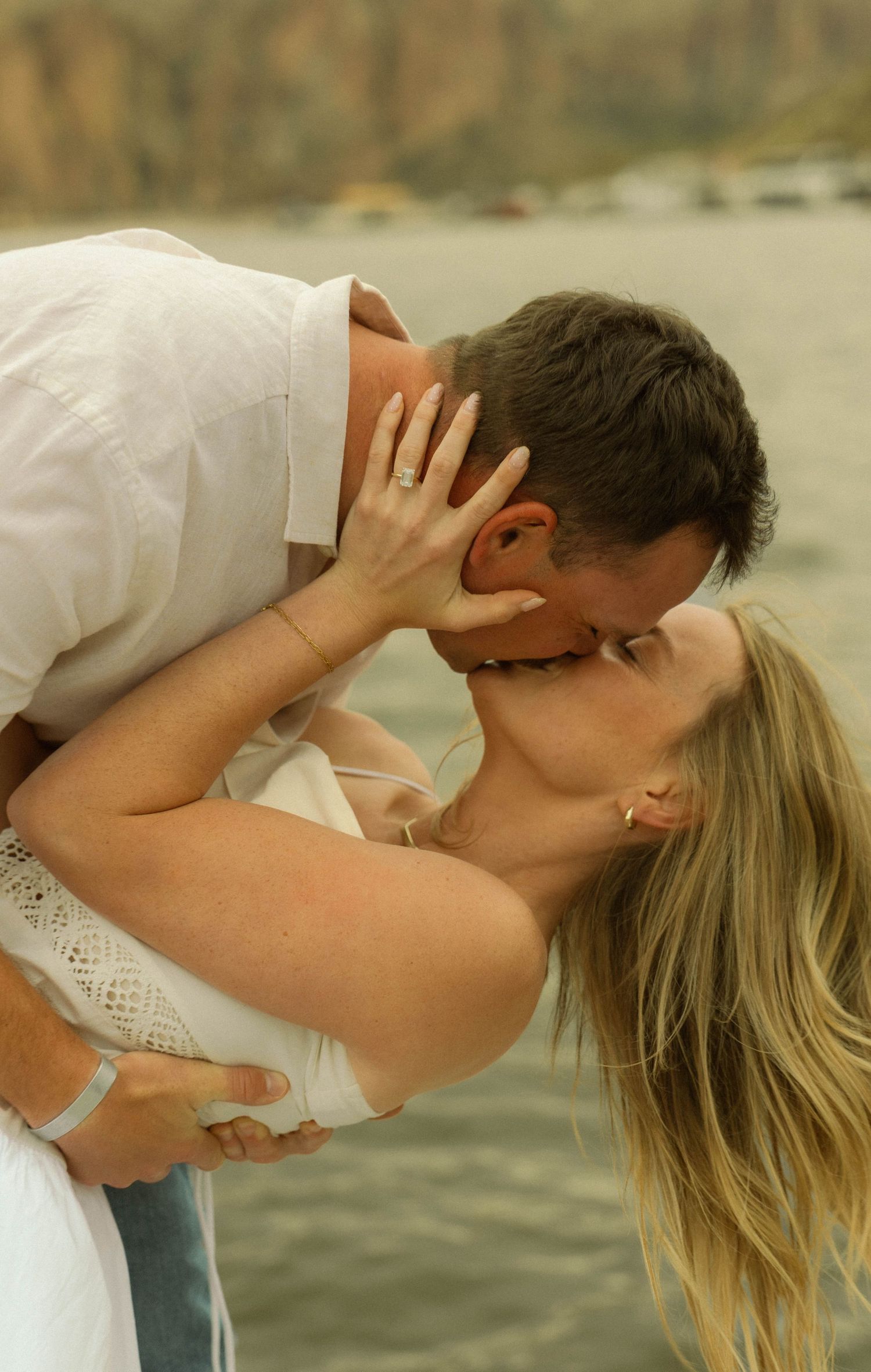 Passionate embrace captured in sequence against mountain lake landscape.