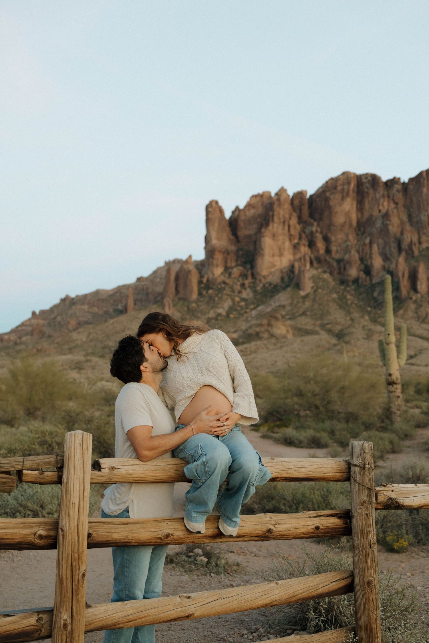A romantic photo sequence on a wooden fence with desert mountains in the background.
