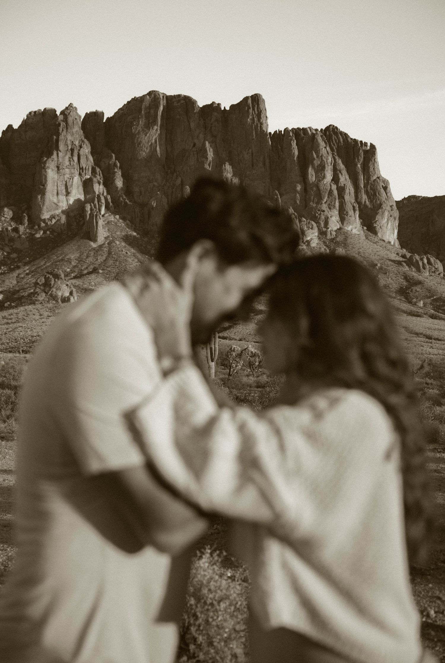 A romantic black and white photo series with desert mountains in the background.