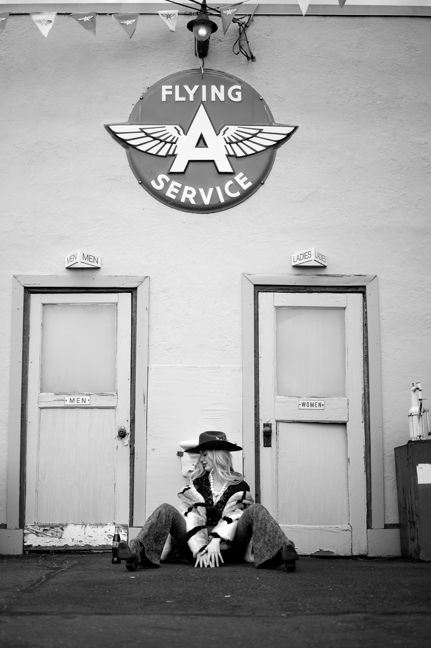 Vintage black and white photograph of a Flying A service station hallway with multiple doors. Portland, Oregon. Creative portfolio.