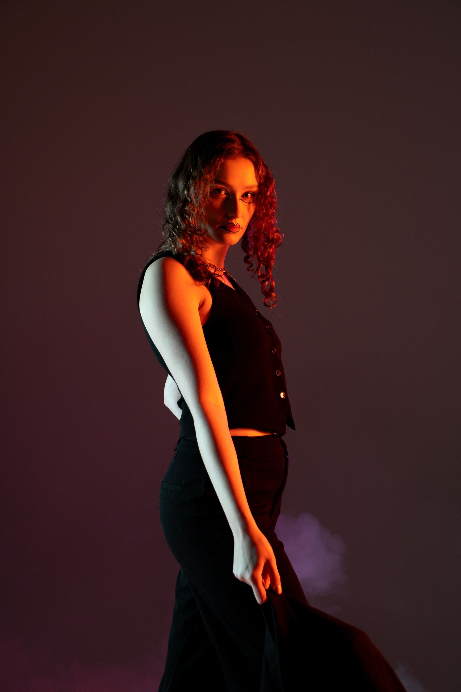 Artistic fashion photo with black crop top and pants in dramatic side lighting. Creative portfolio. Studio. Portrait photography. Oregon.