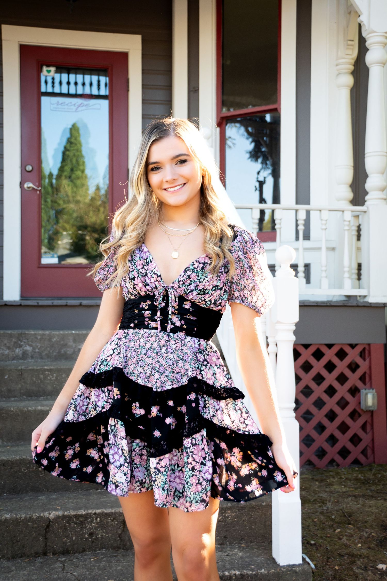 Portrait series on a white porch with red trim and decorative lattice details.