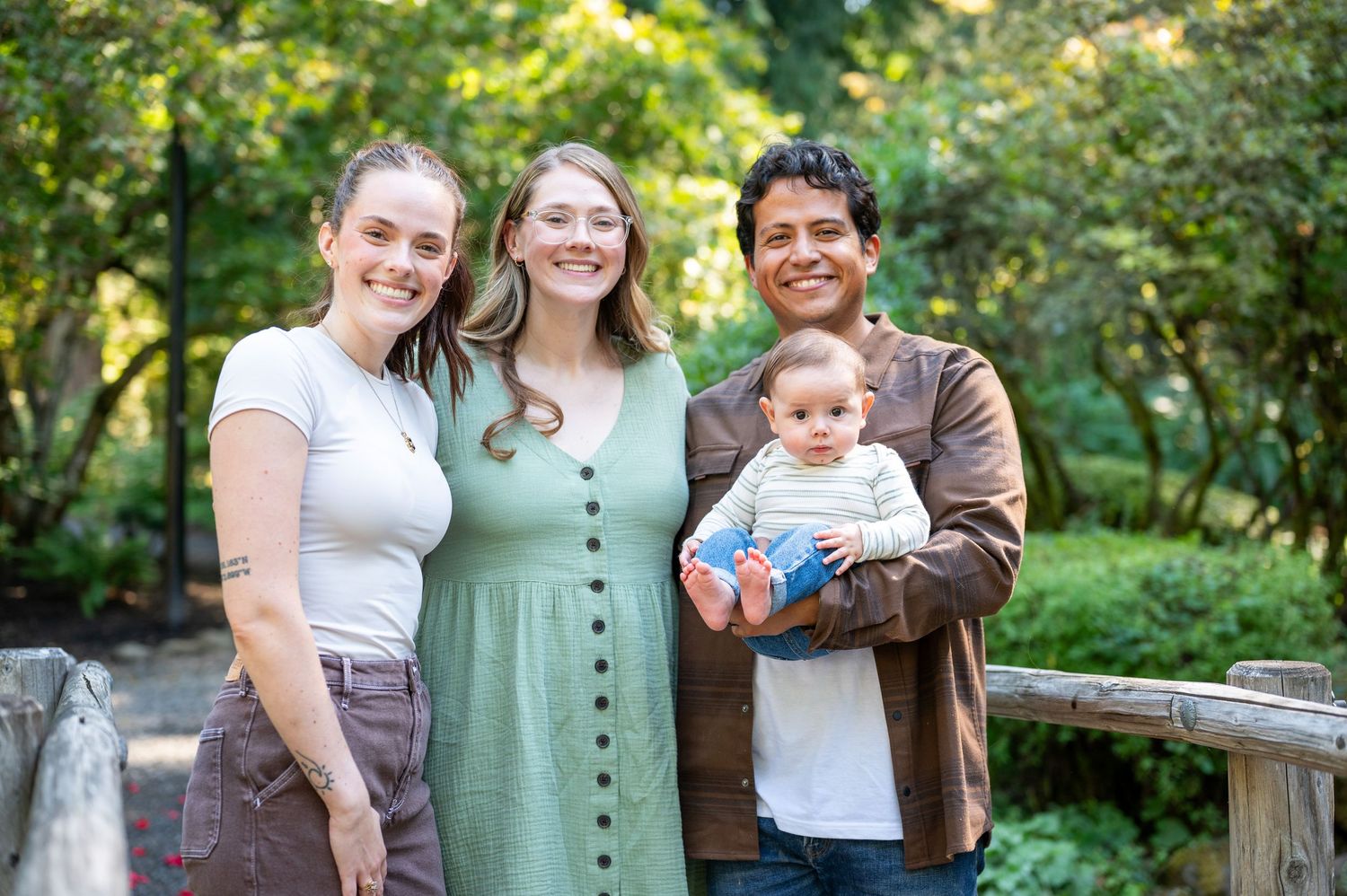 Happy family portrait in a sunlit garden with greenery. Family session. Portrait photography. Oregon.