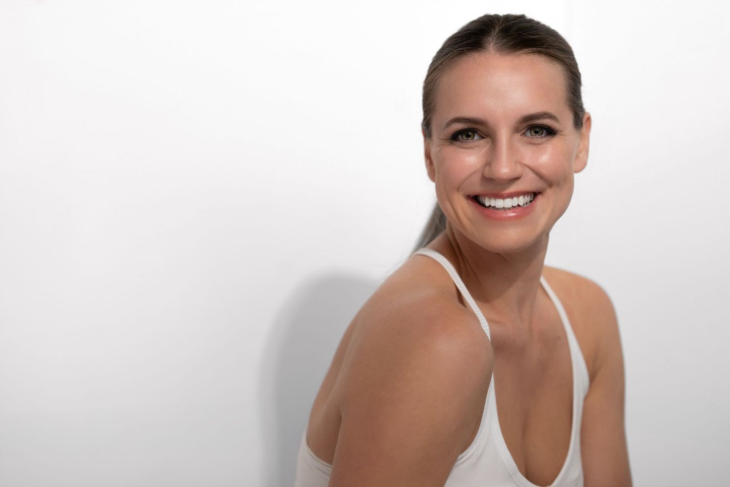 Studio portrait against white background showcasing natural beauty and confidence. Self portrait. The Option Agency.