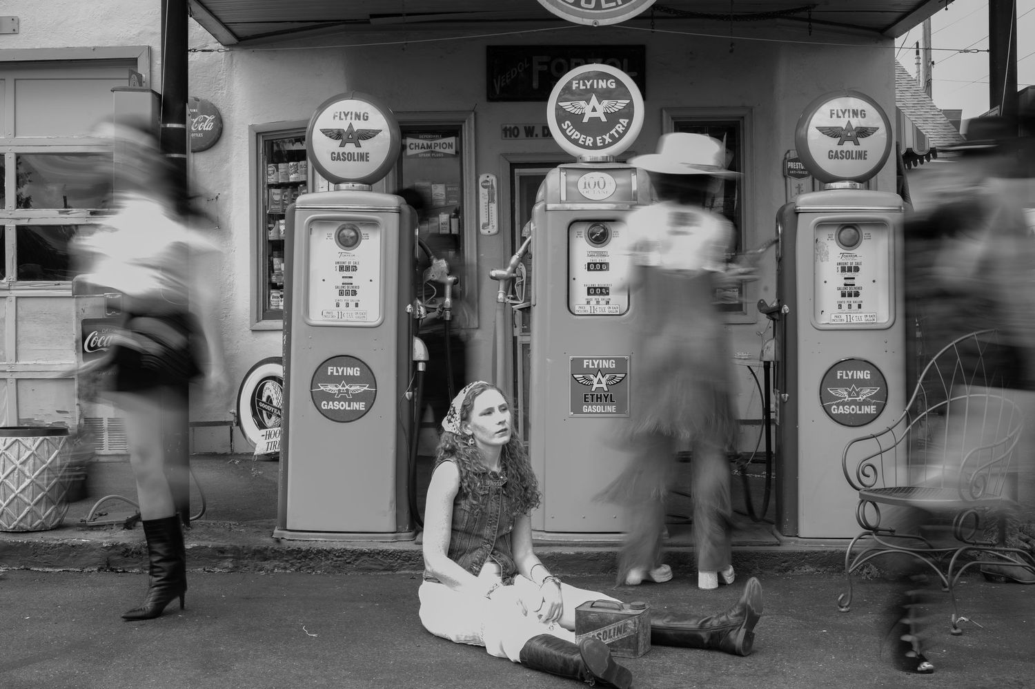 Motion blur photograph of people walking past vintage gas station meters and signs. Portland, Oregon. Creative portfolio.