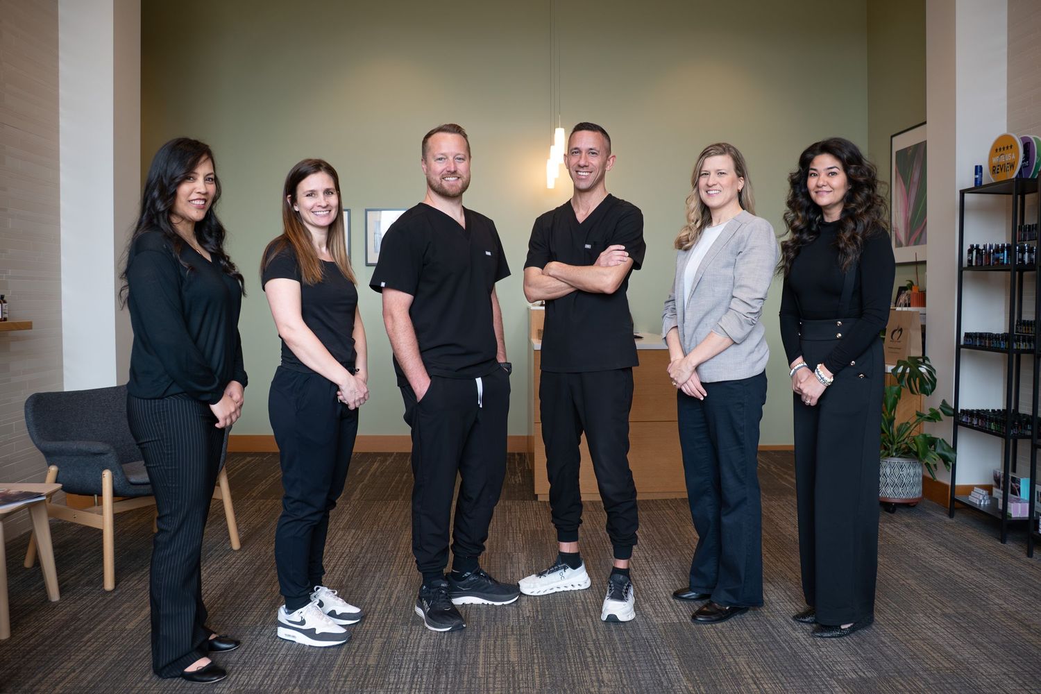 Business team in casual attire stands together in office setting. Business photography. Branding. Beaverton, Oregon.