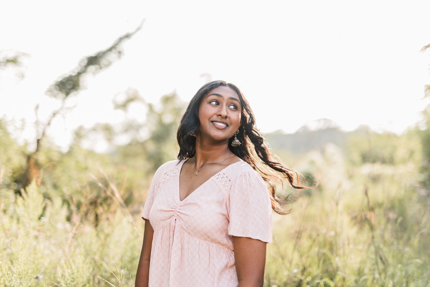 Sun-drenched outdoor portrait session in light summer clothing.