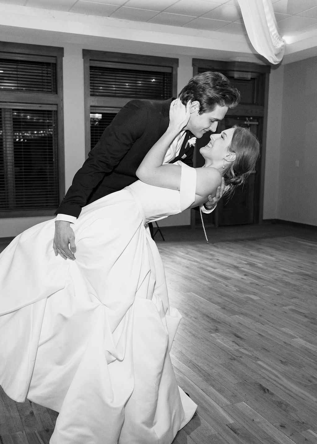 A couple in formal attire sharing an intimate dance pose in a studio setting.