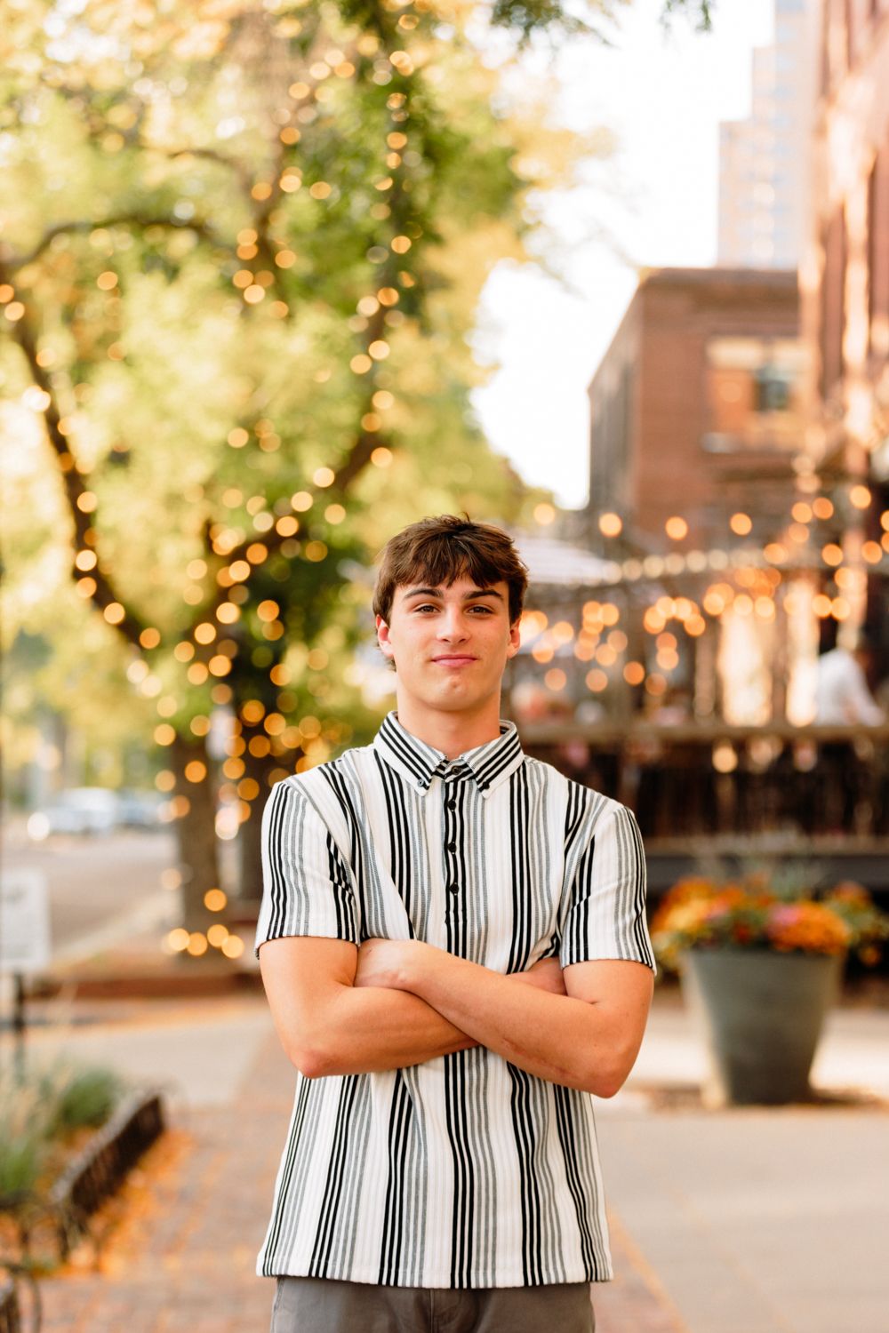 A series of outdoor portrait photos featuring someone wearing a black and white striped shirt in an urban setting with trees.