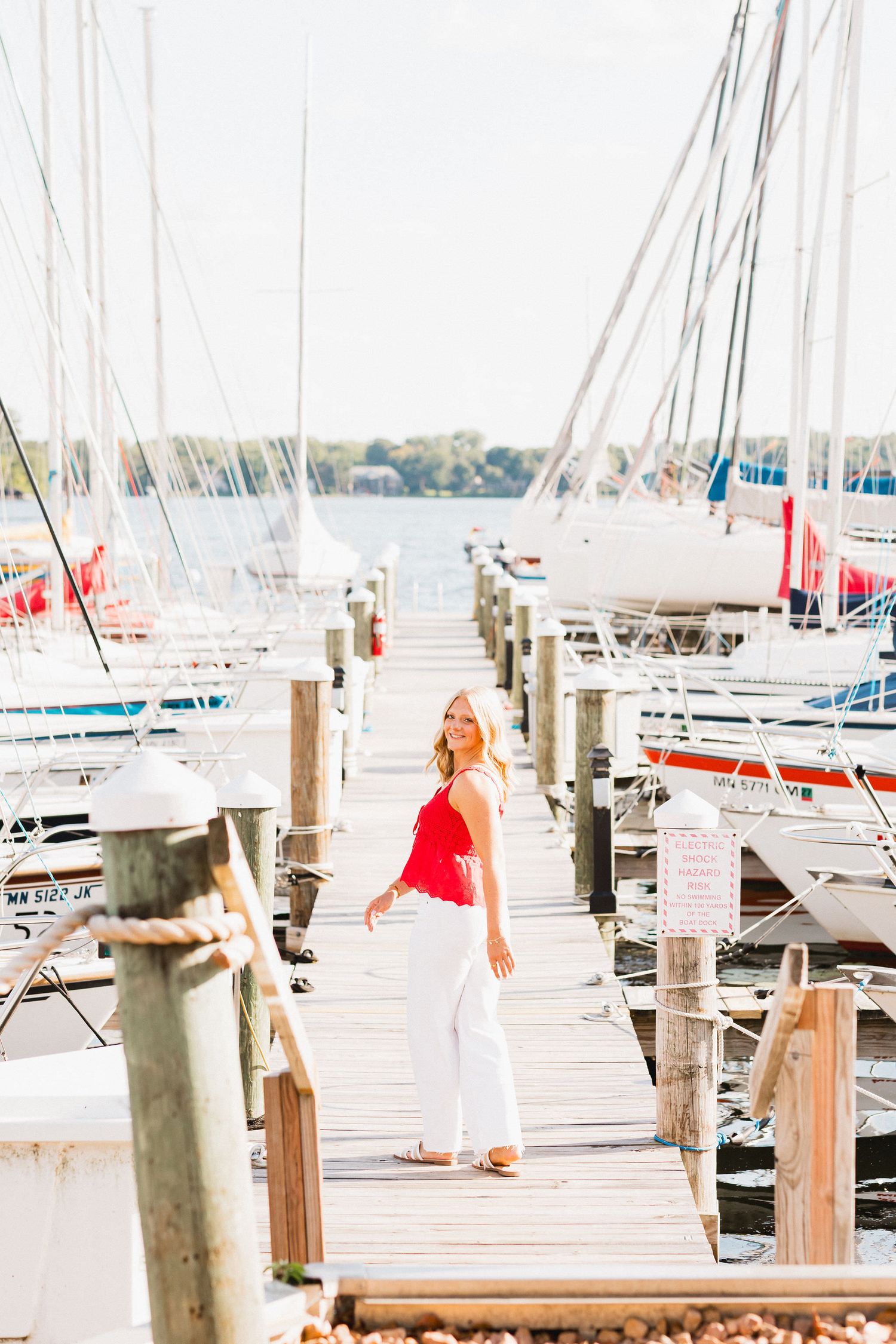 A marina dock scene with sailboats and masts creating a serene waterfront atmosphere.