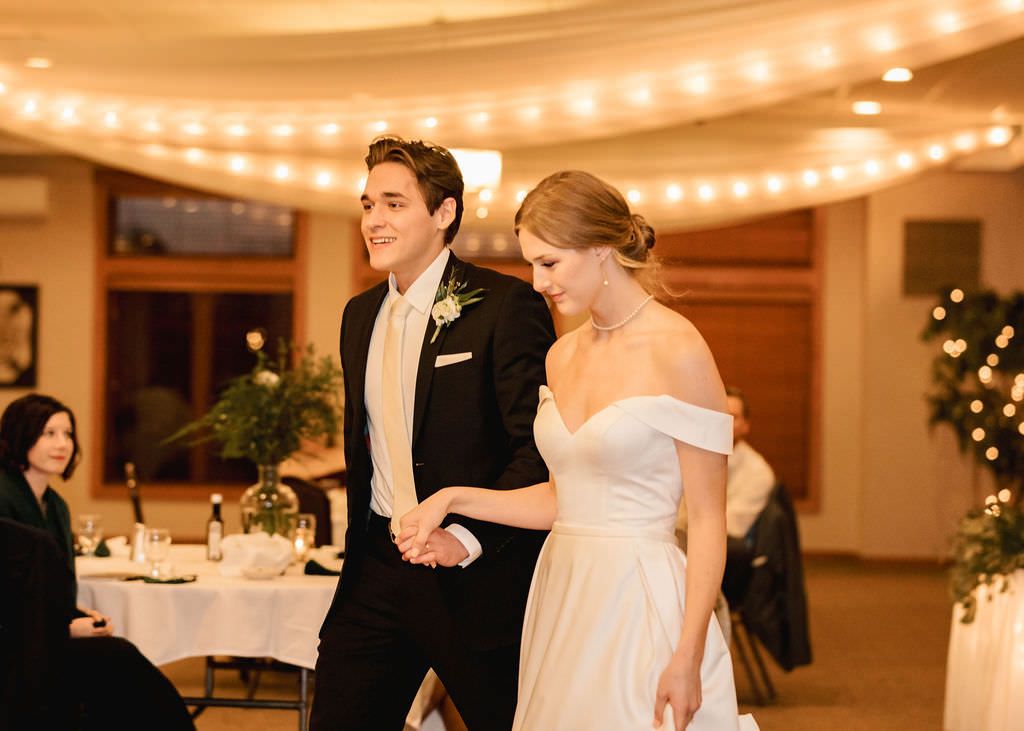 Wedding ceremony and reception venue with string lights and festive decor.