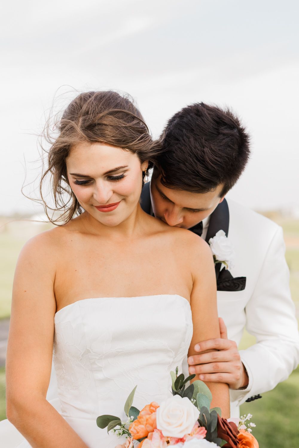 Bride in white dress and groom in suit share tender moments in a series of outdoor wedding photos.
