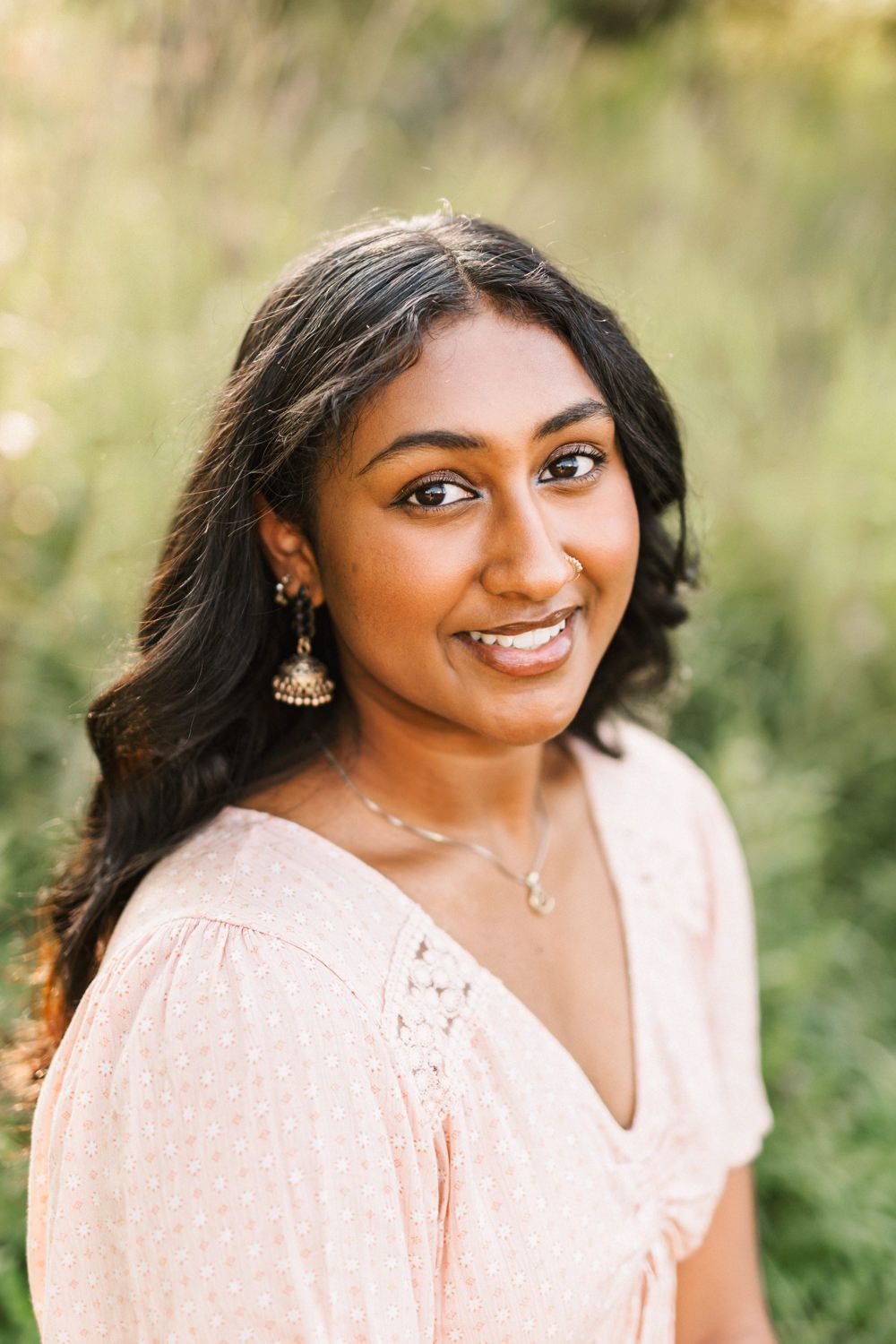 Golden hour portraits featuring delicate pink dress and natural expressions.