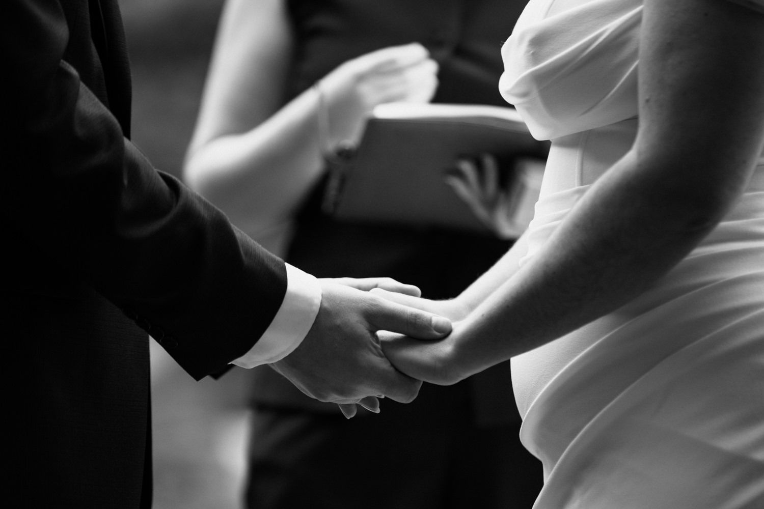 Artistic black and white close-up shots capturing intimate wedding ceremony moments.