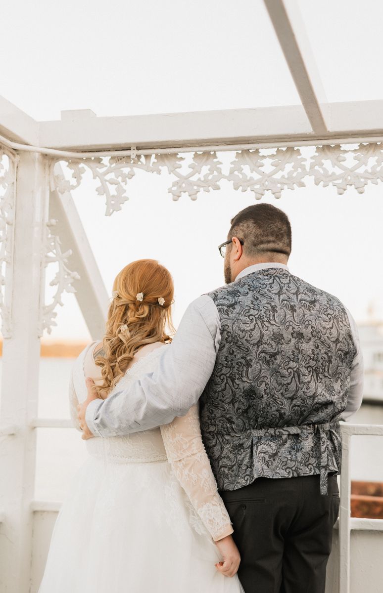 Romantic dance sequence under a white tent with decorative lace details and soft lighting.