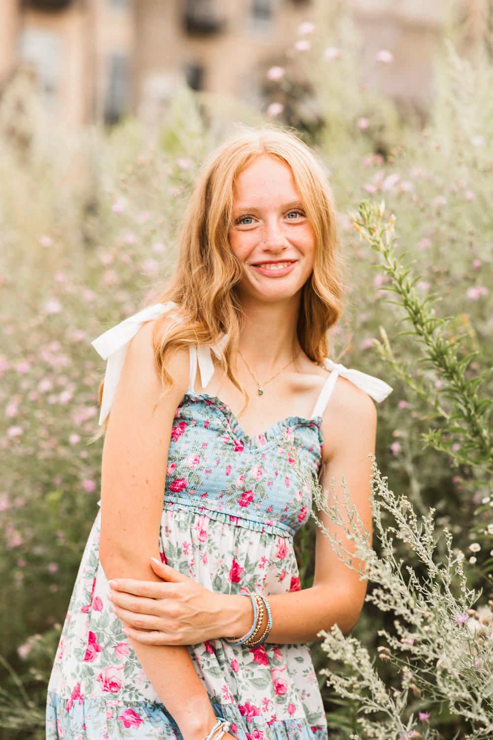 A four-panel collage shows someone in a floral dress sitting in a wildflower field on a sunny summer day.
