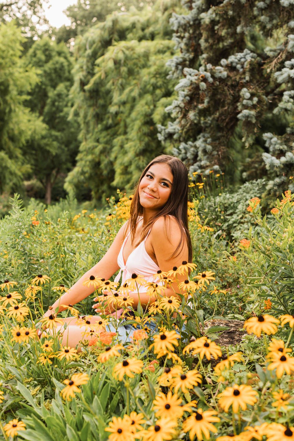 Beautiful outdoor portrait photography session in a field of vibrant yellow black-eyed susan flowers.