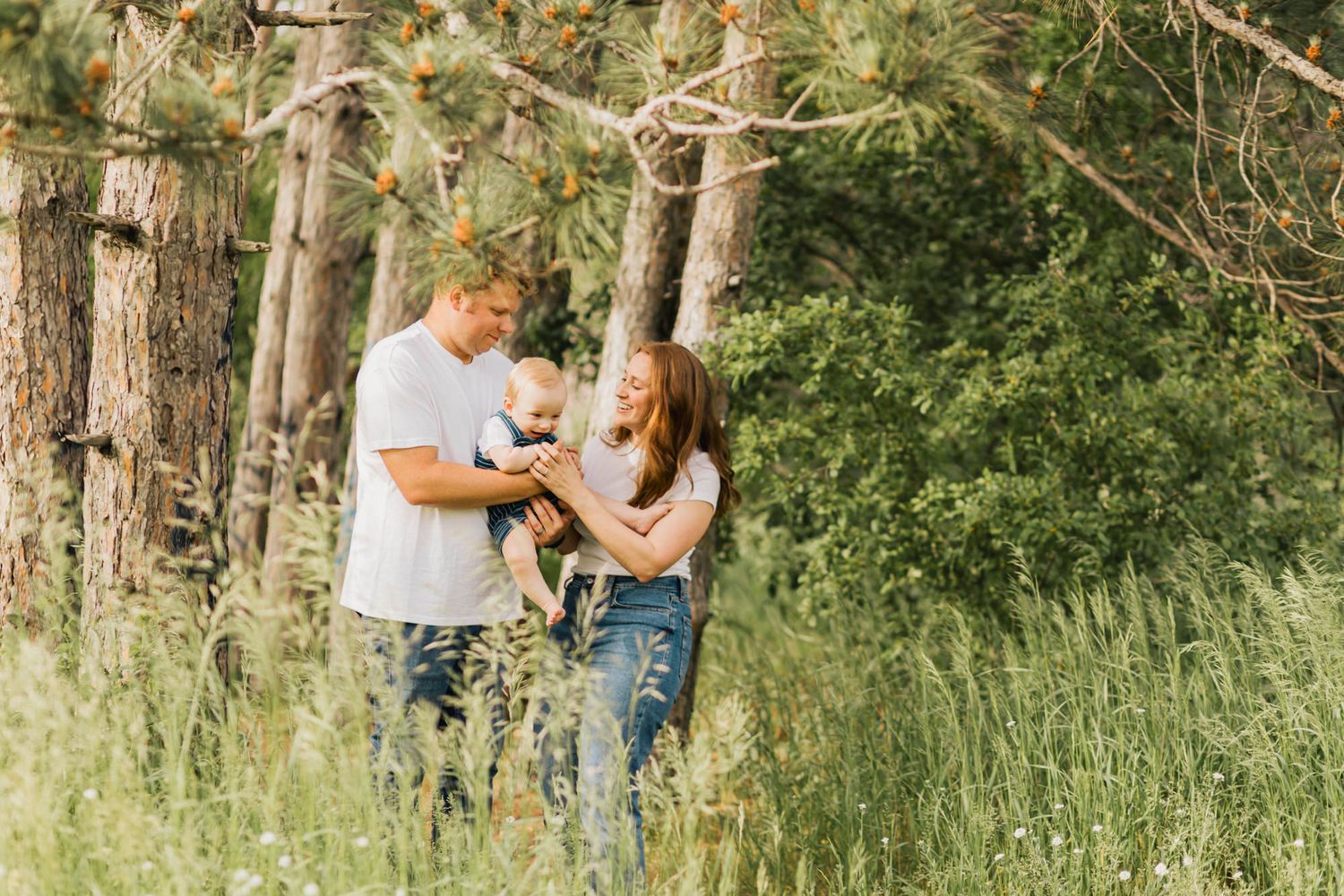Extended family poses together outdoors for casual portraits in a natural park setting.