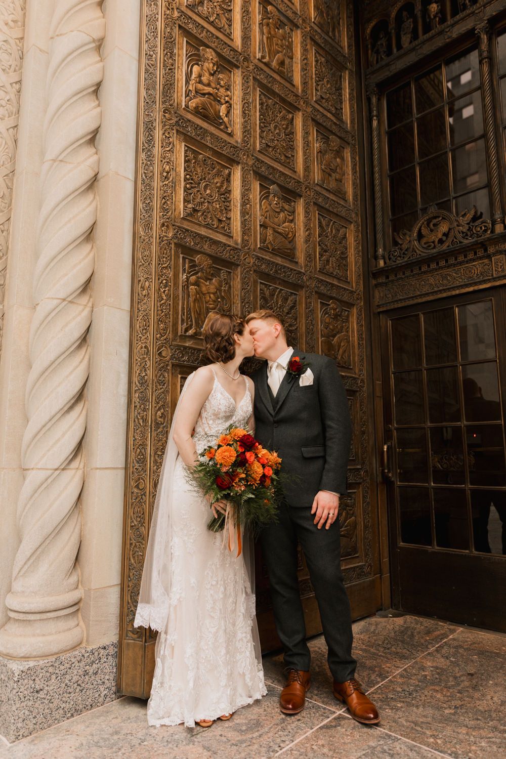 Romantic wedding portraits against ornate architectural columns and decorative metalwork.