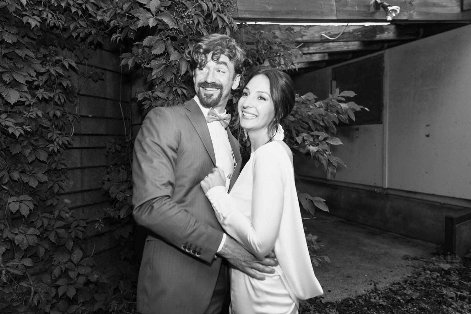 A romantic black and white photo series of a couple embracing outdoors.