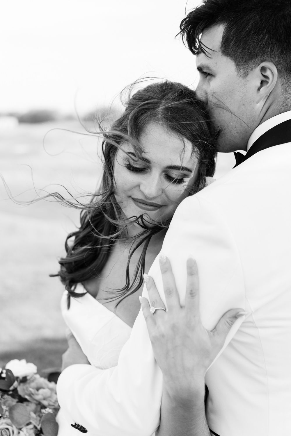 Black and white portrait of a romantic wedding couple sharing an intimate moment together.