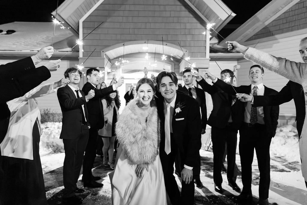Black and white wedding party photo series showing celebratory moments outdoors.