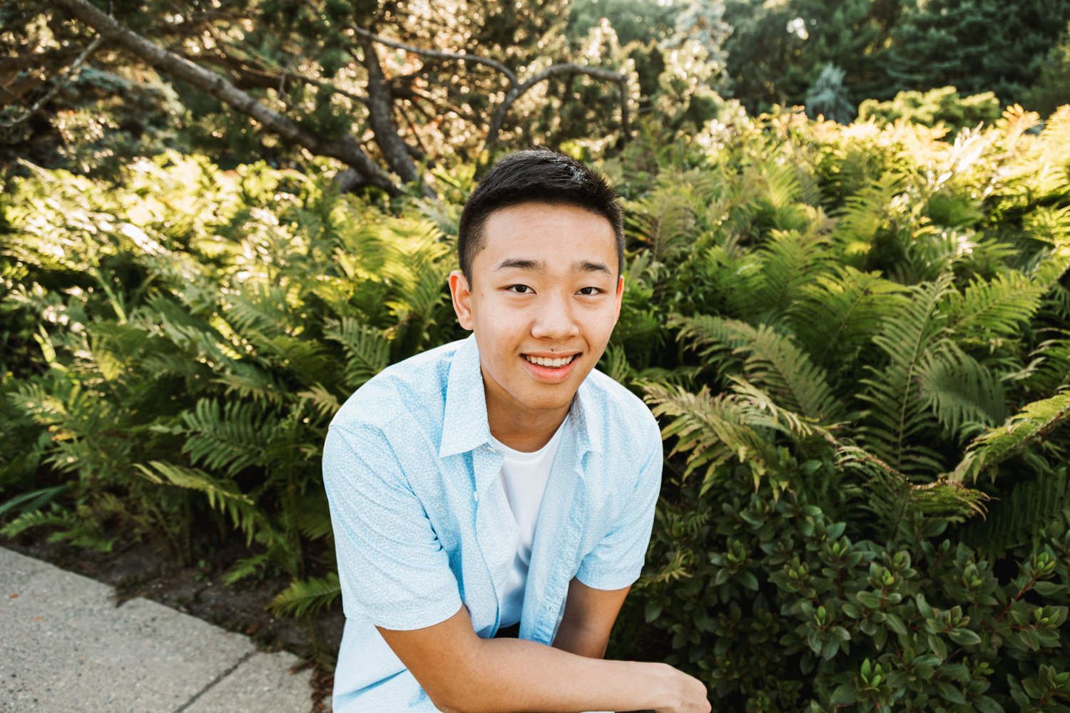 Relaxed outdoor photo session in a garden with green foliage background.