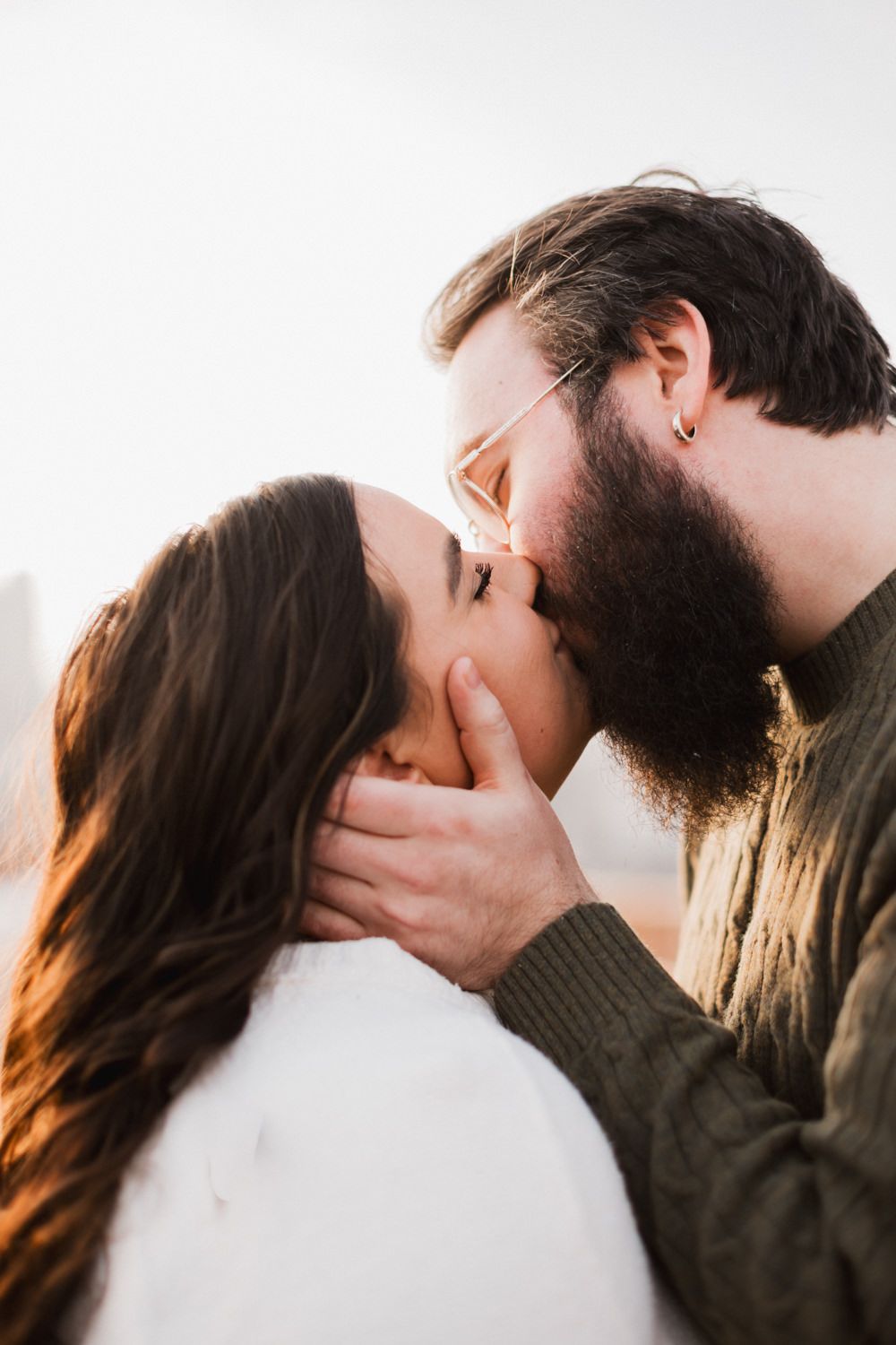 A romantic couple shares an intimate kiss in a series of candid photographs showing their affection.