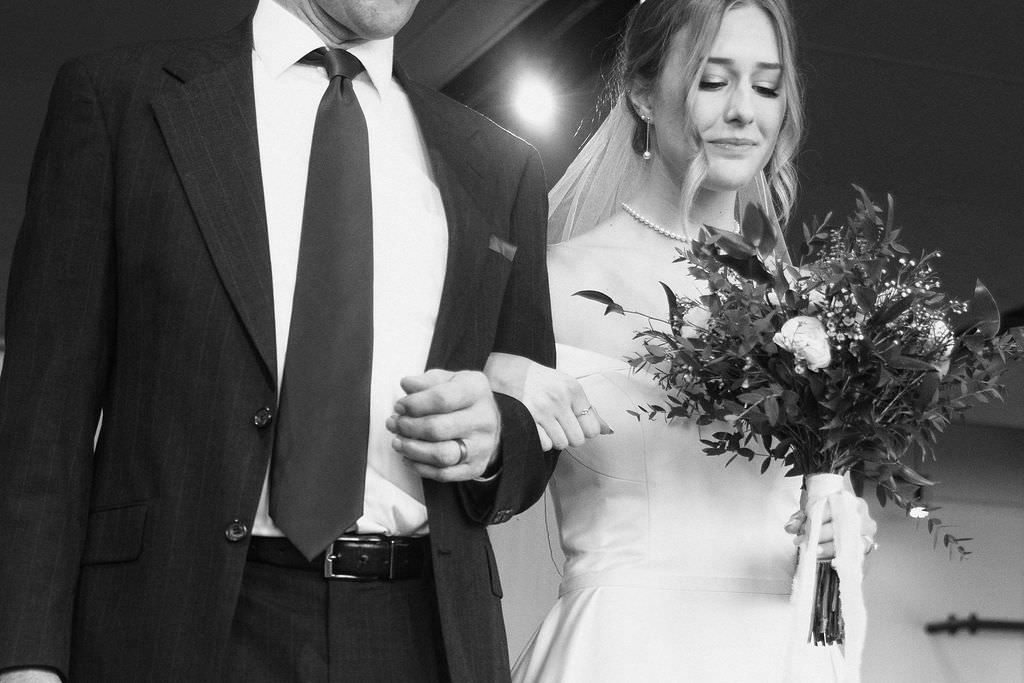 A romantic black and white wedding photo series showing intimate moments between newlyweds in formal attire.
