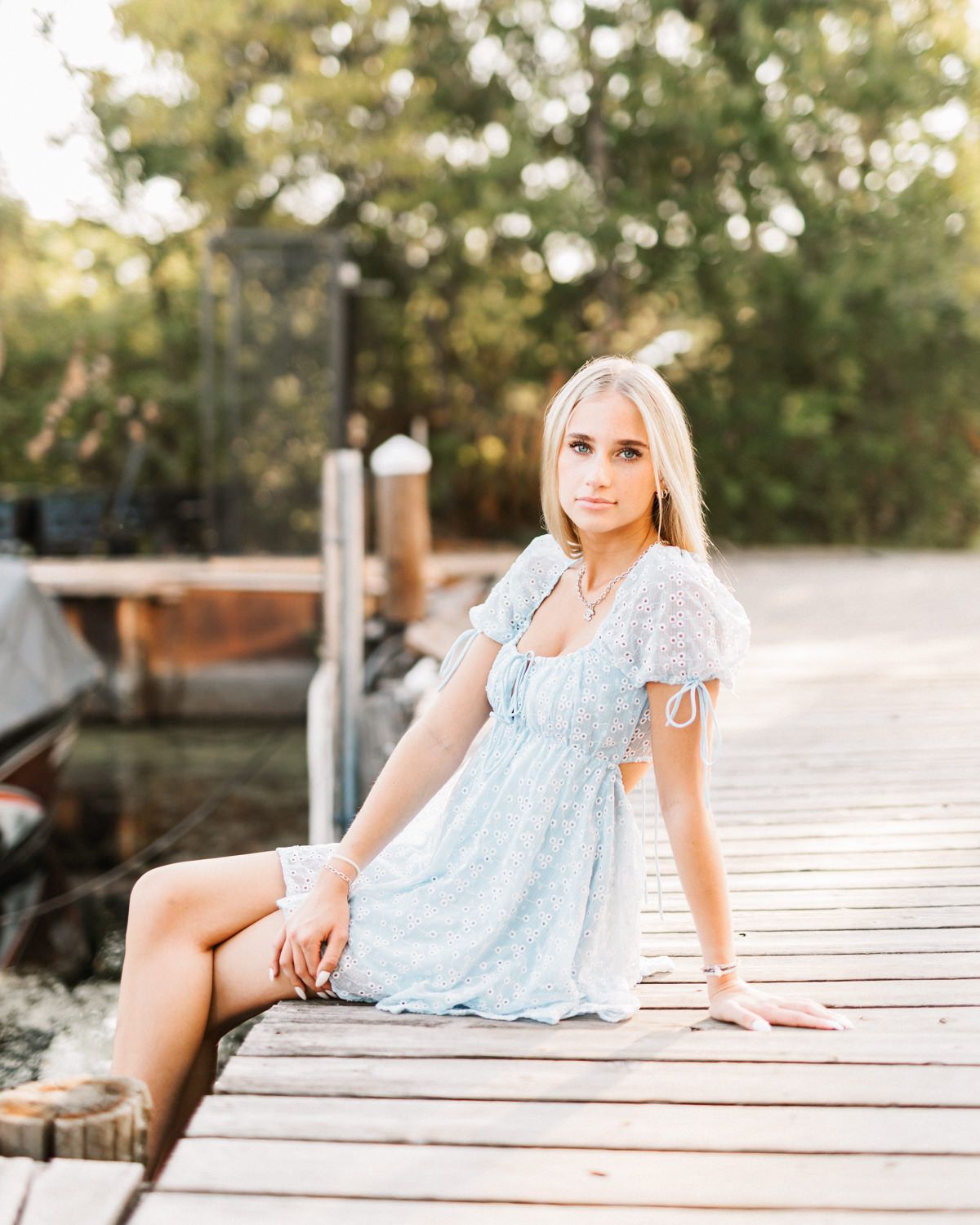 Summer photography session on rustic wooden boards with dreamy outdoor lighting.