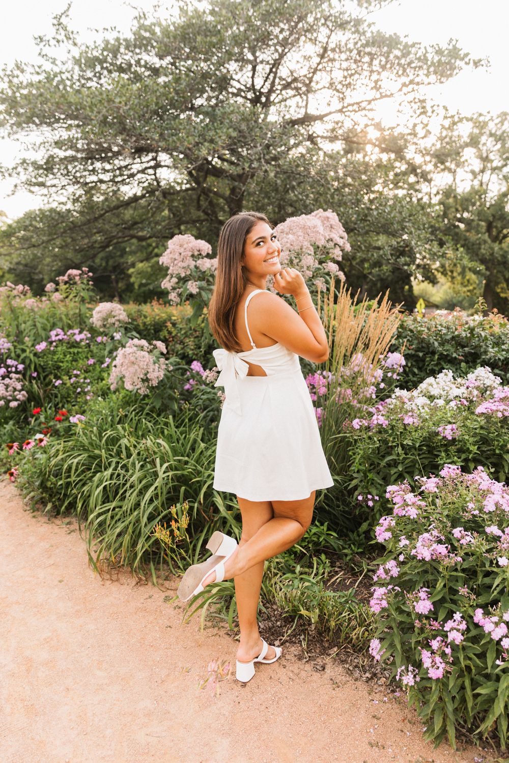 Fashion photo series near blooming purple flowers and ornamental grasses at sunset.